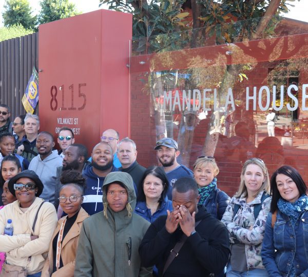 MaxProf employees pictured in front of Nelson Mandela's family home on Vilakazi Street in Orlando